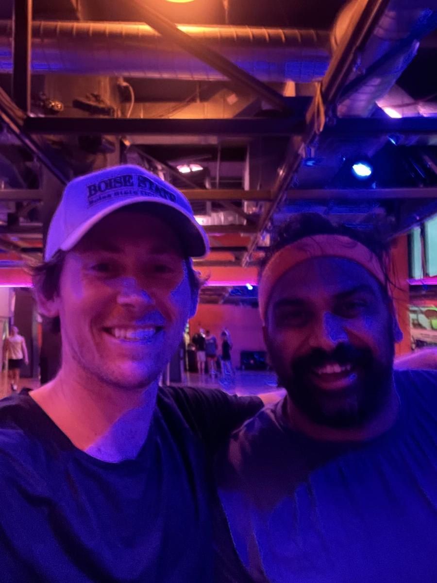 Aaron and Nipun under purple lights at Crunch Chelsea